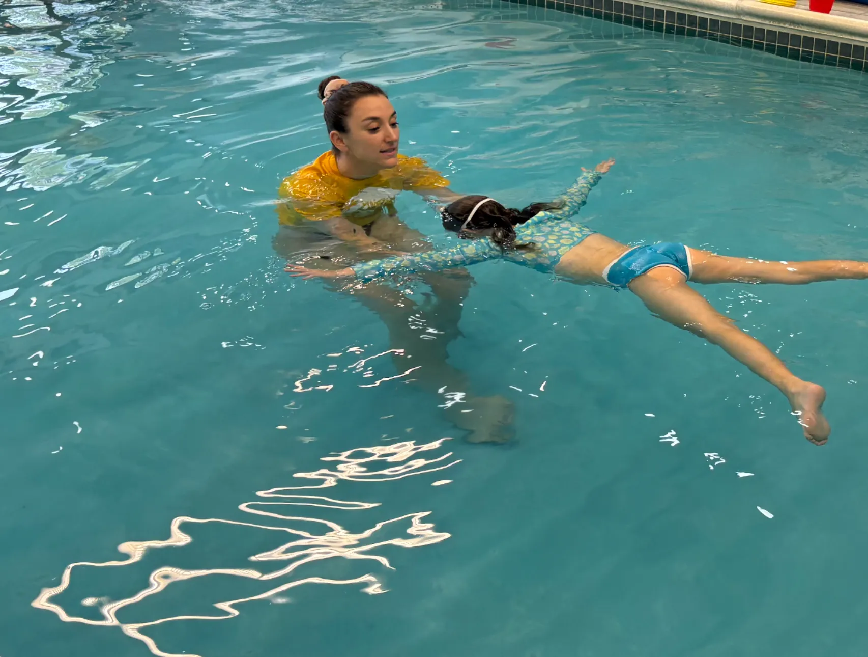Preschool swimmer practicing with an instructor